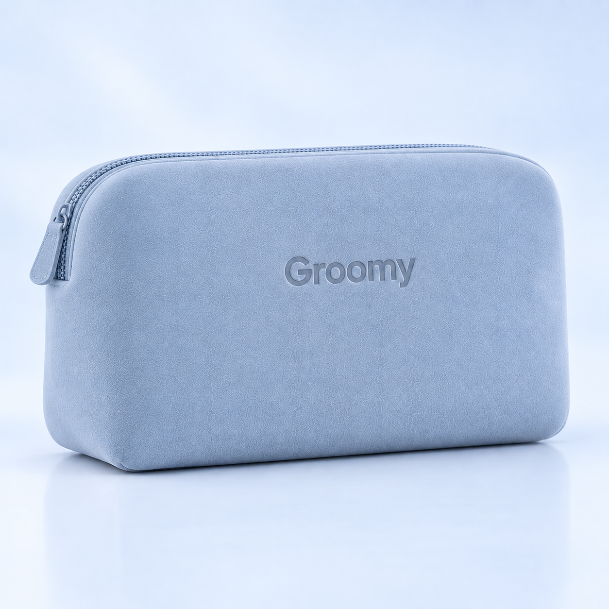 Groomy Editorial Blue suede travel pouch with zip closure and debossed logo.